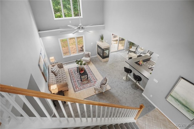 9712 Kingussle Ln, North Chesterfield, VA 23236 - tiled living room with a towering ceiling, carpet, stairway, and a ceiling fan