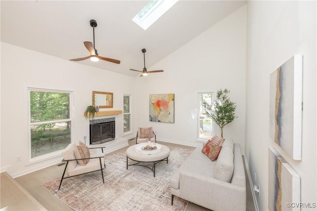 3211 Fox Chase Dr, Midlothian, VA 23112 - living area with a skylight, a fireplace with raised hearth, high vaulted ceiling, and wood finished floors