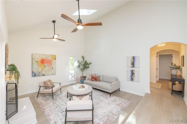 3211 Fox Chase Dr, Midlothian, VA 23112 - living room with high vaulted ceiling, arched walkways, light wood finished floors, a ceiling fan, and a skylight