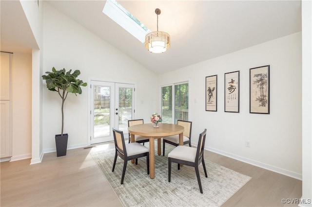 3211 Fox Chase Dr, Midlothian, VA 23112 - dining room featuring light wood finished floors, a skylight, high vaulted ceiling, and french doors