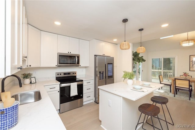 3211 Fox Chase Dr, Midlothian, VA 23112 - kitchen featuring stainless steel appliances, a kitchen breakfast bar, white cabinets, light countertops, and recessed lighting
