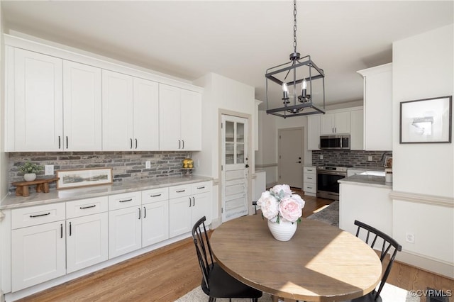 10703 Kriserin Cir, Chester, VA 23831 - dining space featuring a chandelier and light wood-style flooring