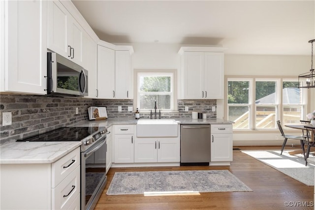 10703 Kriserin Cir, Chester, VA 23831 - kitchen with appliances with stainless steel finishes, healthy amount of natural light, light wood finished floors, and white cabinetry