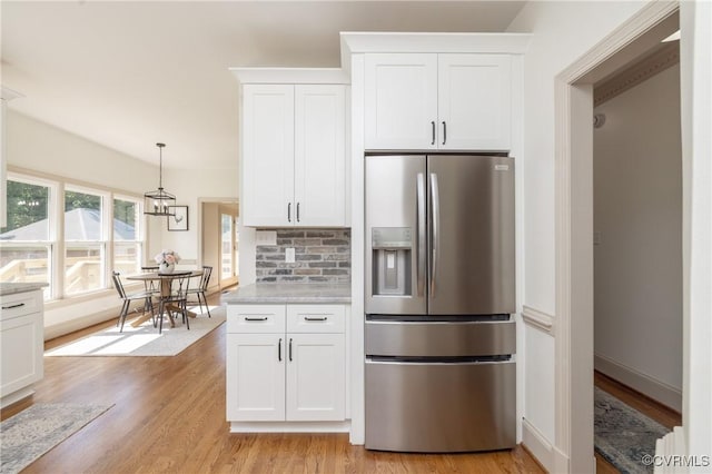 10703 Kriserin Cir, Chester, VA 23831 - kitchen featuring stainless steel fridge, light wood finished floors, white cabinets, decorative light fixtures, and decorative backsplash