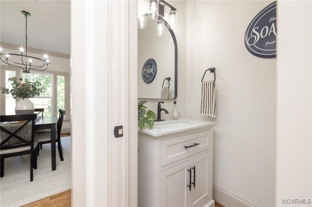 10703 Kriserin Cir, Chester, VA 23831 - bathroom featuring a chandelier, vanity, and wood finished floors