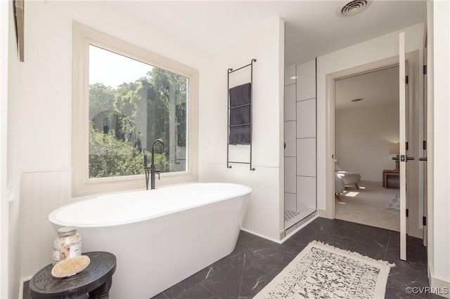10703 Kriserin Cir, Chester, VA 23831 - bathroom with marble tiled flooring, a freestanding bath, and a wainscoted wall
