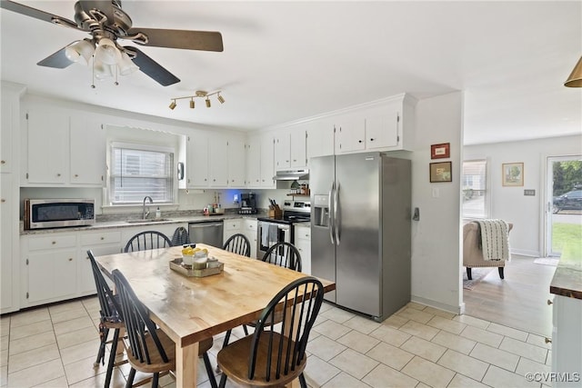 7085 Foxlair Dr, Mechanicsville, VA 23111 - kitchen featuring appliances with stainless steel finishes, light tile patterned flooring, white cabinetry, a ceiling fan, and light countertops