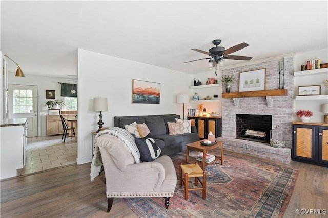 7085 Foxlair Dr, Mechanicsville, VA 23111 - living room featuring a ceiling fan, wood finished floors, and a brick fireplace
