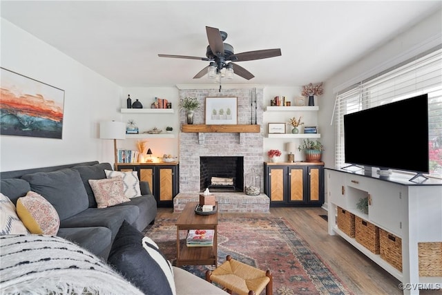 7085 Foxlair Dr, Mechanicsville, VA 23111 - living room with wood finished floors, ceiling fan, and a brick fireplace