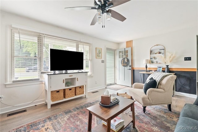 7085 Foxlair Dr, Mechanicsville, VA 23111 - living area with wood finished floors, a ceiling fan, and plenty of natural light