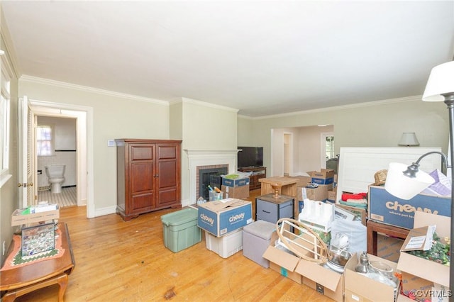 1939 Cumberland Ave, Petersburg, VA 23805 - living room featuring light wood-type flooring, crown molding, and a brick fireplace