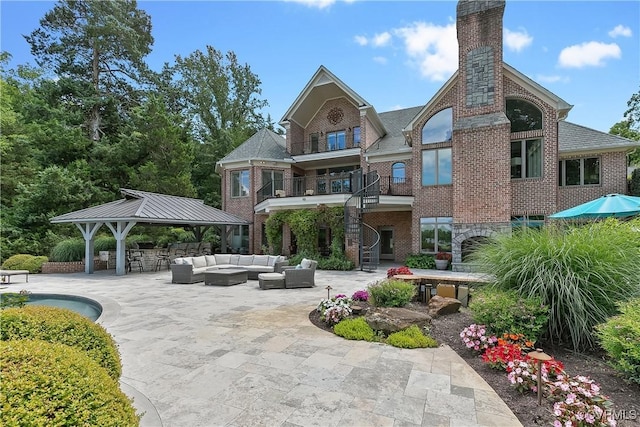 3300 Riverglade Rd, Powhatan, VA 23139 - back of property with an outdoor hangout area, a patio, stairway, brick siding, and a gazebo