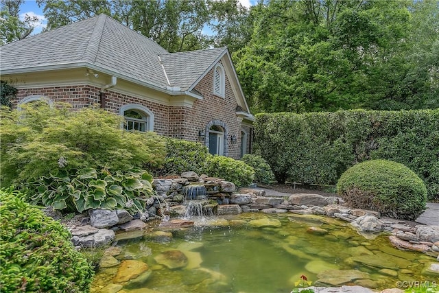 3300 Riverglade Rd, Powhatan, VA 23139 - view of home's exterior featuring a small pond and brick siding