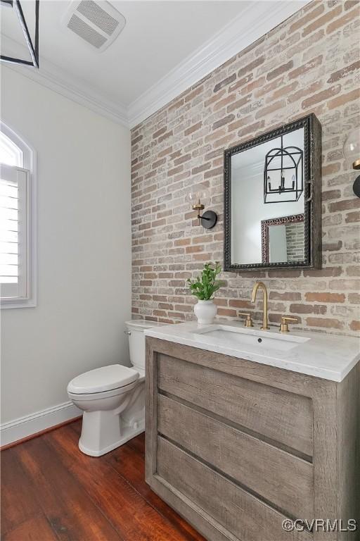 3300 Riverglade Rd, Powhatan, VA 23139 - half bathroom featuring vanity, ornamental molding, wood finished floors, and brick wall