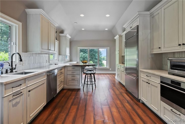 3300 Riverglade Rd, Powhatan, VA 23139 - kitchen featuring appliances with stainless steel finishes, a peninsula, backsplash, dark wood-style floors, and light countertops