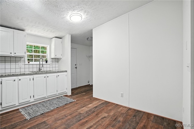 209 Oak Hill Rd, Prospect, VA 23960 - kitchen featuring dark wood-style flooring, tasteful backsplash, white cabinetry, light stone counters, and a textured ceiling
