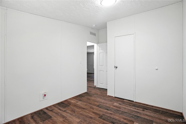 209 Oak Hill Rd, Prospect, VA 23960 - unfurnished bedroom featuring dark wood-style floors and a textured ceiling