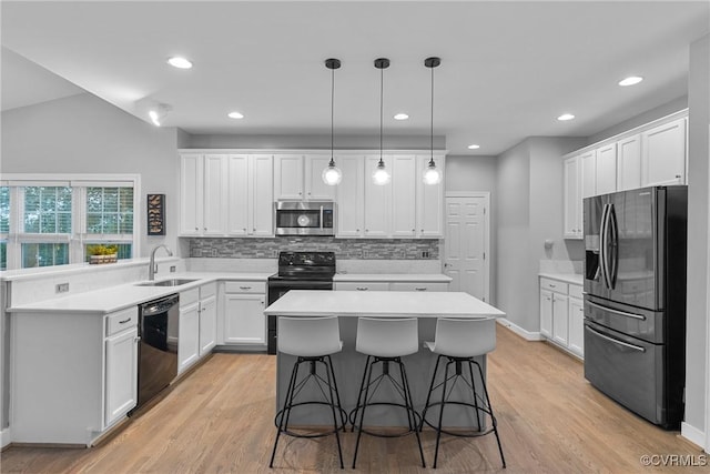 9032 Fascine Ct, Mechanicsville, VA 23116 - kitchen with black appliances, backsplash, a kitchen island, a peninsula, and light wood-style floors
