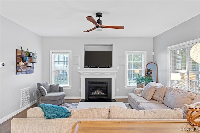 9032 Fascine Ct, Mechanicsville, VA 23116 - living area featuring plenty of natural light, wood finished floors, a ceiling fan, and a fireplace with flush hearth