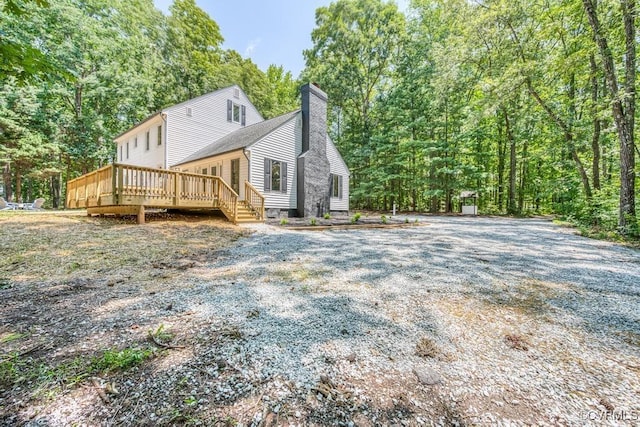 2629 Maidens Rd, Powhatan, VA 23139 - view of home's exterior with a chimney, a deck, and a forest view