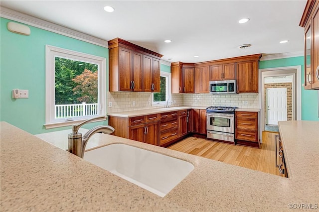 3 Milby Cir, Sandston, VA 23150 - kitchen with stainless steel appliances, tasteful backsplash, light wood-type flooring, ornamental molding, and recessed lighting