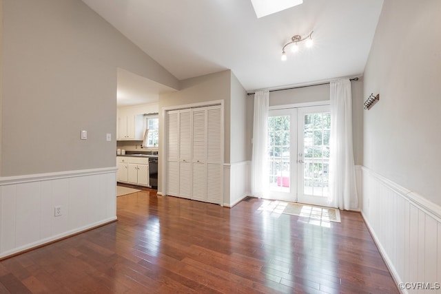 2713 Brookforest Rd, Midlothian, VA 23112 - unfurnished room featuring a wainscoted wall, dark wood-type flooring, a skylight, and vaulted ceiling