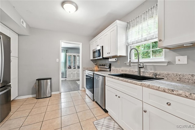16731 Amherst Oak Ln, Chesterfield, VA 23834 - kitchen with stainless steel appliances, white cabinetry, light stone counters, and light tile patterned floors
