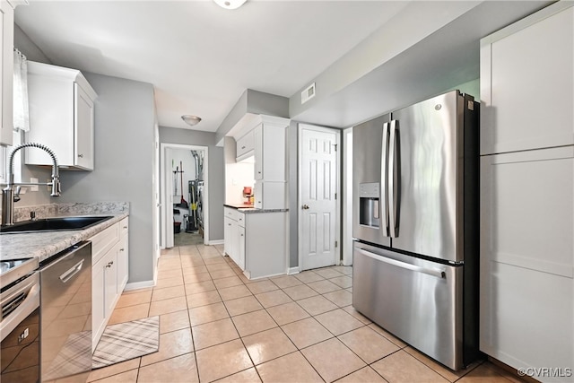 16731 Amherst Oak Ln, Chesterfield, VA 23834 - kitchen featuring appliances with stainless steel finishes, light tile patterned floors, white cabinetry, and light countertops