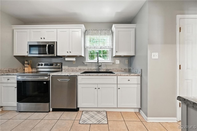 16731 Amherst Oak Ln, Chesterfield, VA 23834 - kitchen with appliances with stainless steel finishes, white cabinetry, light tile patterned floors, and light stone counters