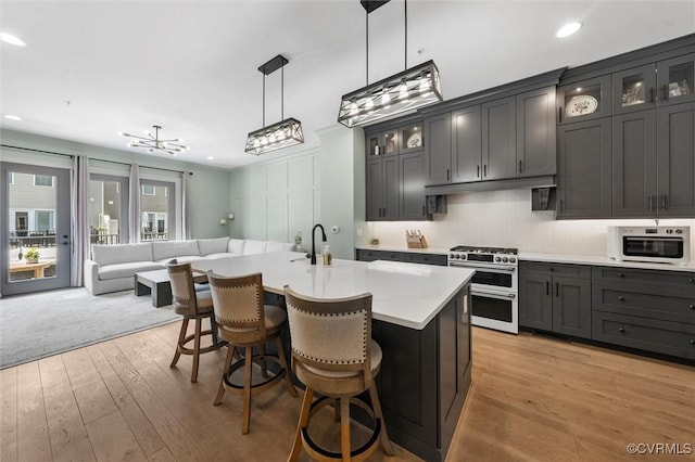 12340 Purbrook Walk, Henrico, VA 23233 - kitchen with double oven range, light countertops, light wood-style flooring, open floor plan, and a breakfast bar area