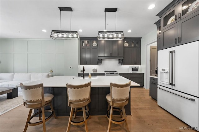 12340 Purbrook Walk, Henrico, VA 23233 - kitchen featuring high end white refrigerator, light countertops, pendant lighting, a kitchen breakfast bar, and recessed lighting
