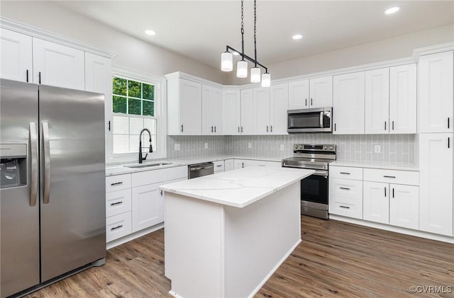 24 Hummingbird Ln, Cumberland, VA 23040 - kitchen featuring stainless steel appliances, dark wood finished floors, white cabinets, backsplash, and a kitchen island