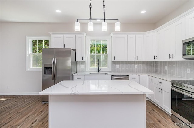 24 Hummingbird Ln, Cumberland, VA 23040 - kitchen featuring stainless steel appliances, light wood-style floors, healthy amount of natural light, white cabinetry, and recessed lighting