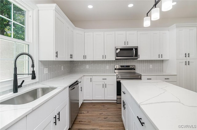 24 Hummingbird Ln, Cumberland, VA 23040 - kitchen featuring appliances with stainless steel finishes, white cabinets, recessed lighting, tasteful backsplash, and hanging light fixtures