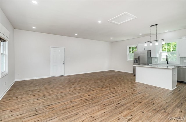 24 Hummingbird Ln, Cumberland, VA 23040 - unfurnished living room featuring light wood finished floors, recessed lighting, and attic access