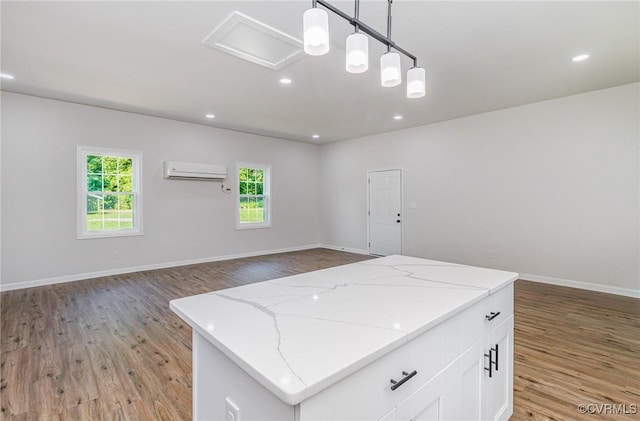 24 Hummingbird Ln, Cumberland, VA 23040 - kitchen featuring a wall unit AC, light wood finished floors, open floor plan, and recessed lighting