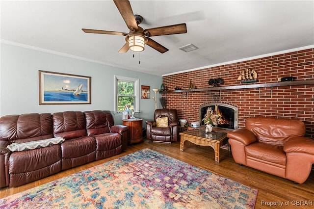 77 Kent Cove Rd, Kilmarnock, VA 22482 - living area with ceiling fan, wood finished floors, a fireplace, crown molding, and brick wall
