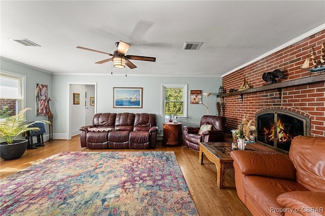 77 Kent Cove Rd, Kilmarnock, VA 22482 - living room with wood finished floors, ceiling fan, ornamental molding, and a fireplace