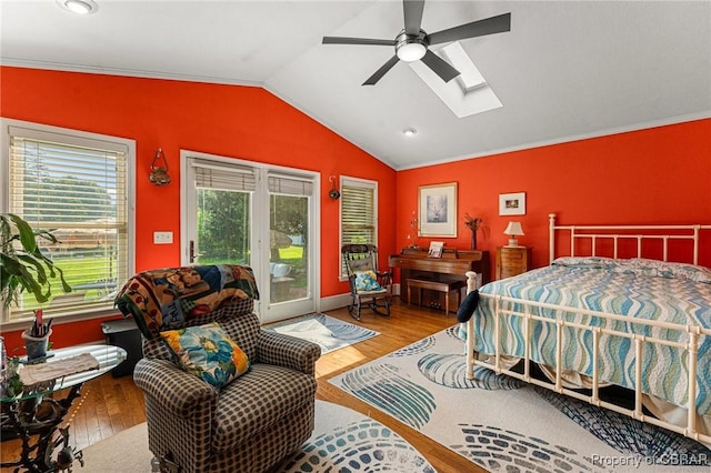 77 Kent Cove Rd, Kilmarnock, VA 22482 - bedroom with access to exterior, vaulted ceiling, wood finished floors, a skylight, and ornamental molding