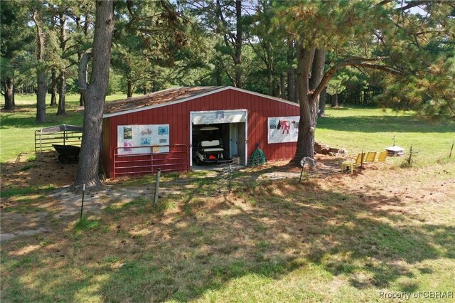 77 Kent Cove Rd, Kilmarnock, VA 22482 - view of pole building featuring a lawn and view of wooded area