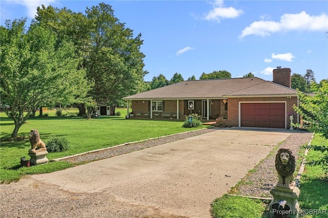 77 Kent Cove Rd, Kilmarnock, VA 22482 - single story home featuring an attached garage, concrete driveway, a front yard, brick siding, and a chimney