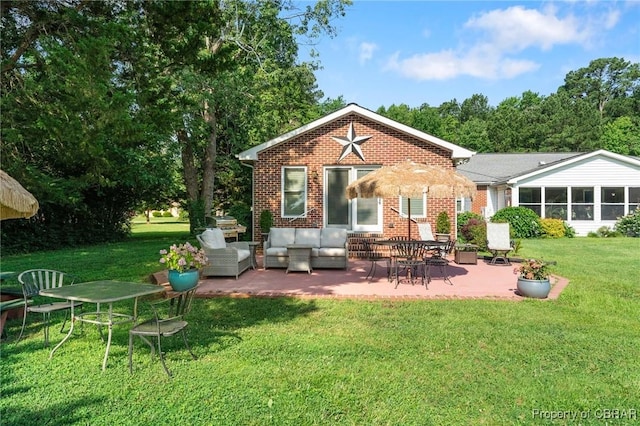 77 Kent Cove Rd, Kilmarnock, VA 22482 - back of property featuring a patio, a lawn, an outdoor living space, and brick siding