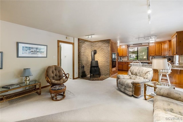 13030 River Hills Dr, Midlothian, VA 23113 - living area with track lighting, a wood stove, and light colored carpet