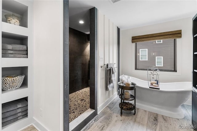 3719 Waverton Dr, Midlothian, VA 23112 - bathroom with wood finished floors, walk in shower, a freestanding tub, and built in features