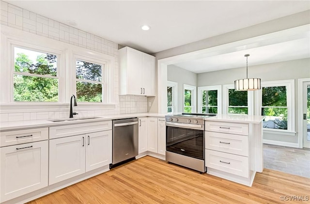 4700 New Kent, Quinton, VA 23141 - kitchen featuring stainless steel appliances, a peninsula, light countertops, tasteful backsplash, and white cabinetry