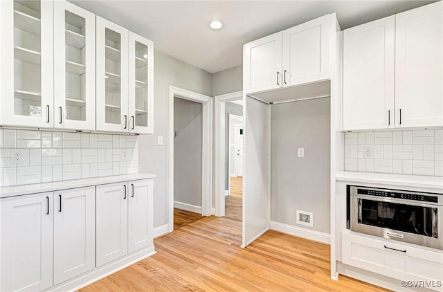 4700 New Kent, Quinton, VA 23141 - kitchen featuring light countertops, decorative backsplash, glass insert cabinets, white cabinetry, and recessed lighting