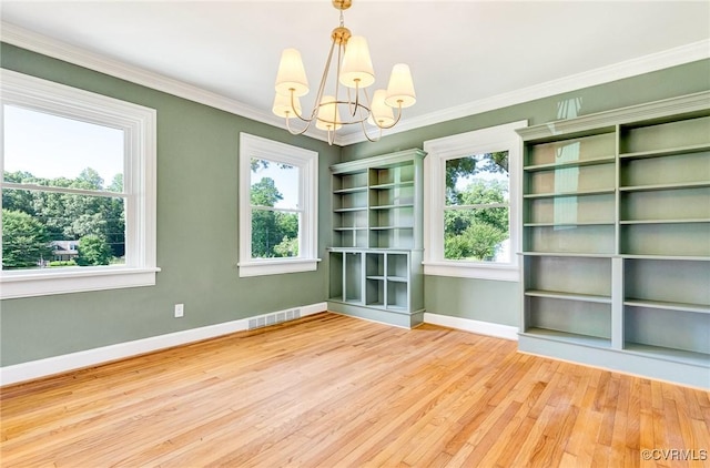 4700 New Kent, Quinton, VA 23141 - empty room featuring a chandelier, wood finished floors, and ornamental molding