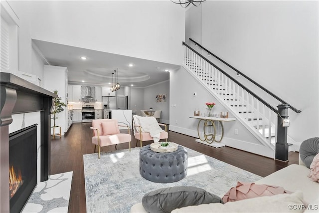 208 Minor St, Richmond, VA 23222 - living area featuring a lit fireplace, stairway, crown molding, recessed lighting, and wood finished floors