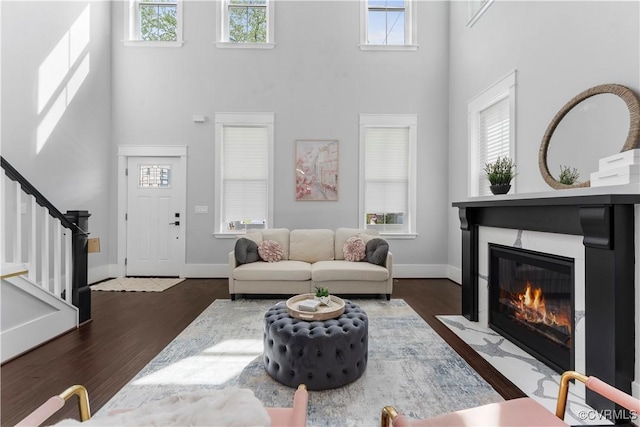 208 Minor St, Richmond, VA 23222 - living room with a towering ceiling, stairs, wood finished floors, and a fireplace with flush hearth