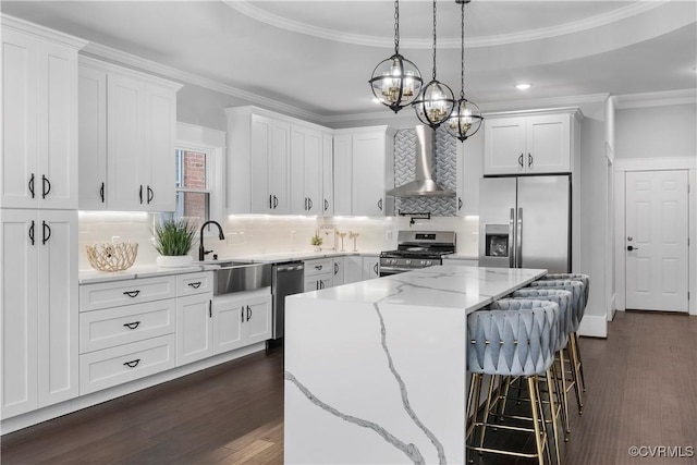 208 Minor St, Richmond, VA 23222 - kitchen featuring appliances with stainless steel finishes, wall chimney exhaust hood, dark wood-style floors, a kitchen island, and crown molding
